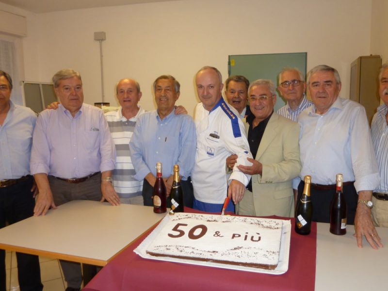 Un gruppo di uomini davanti ad una torta