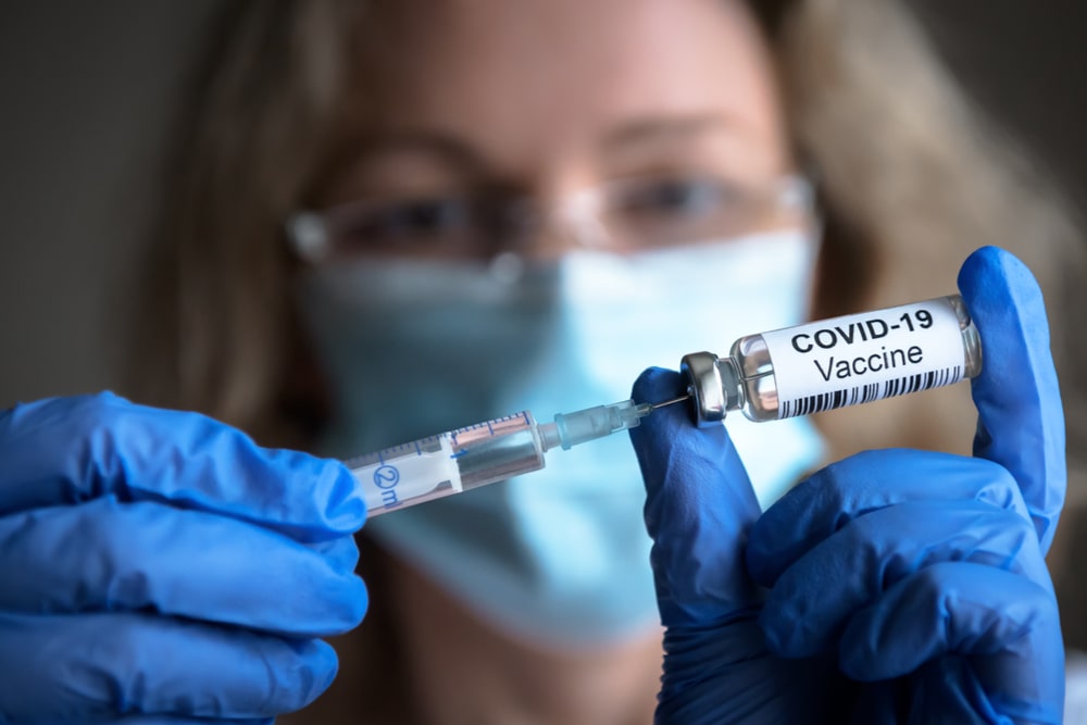 Una donna si prepara ad iniettare il vaccino